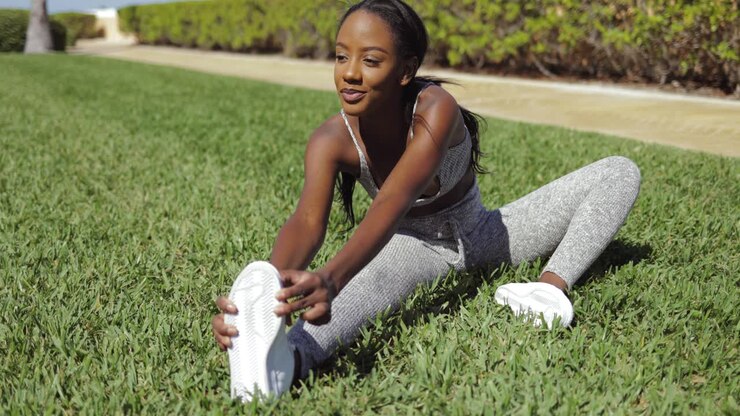 Woman stretching on lawn