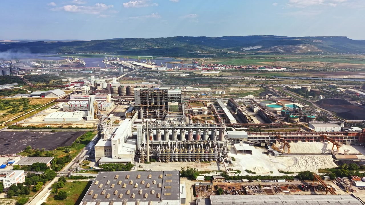 Industrial site near river with factories and equipment during day
