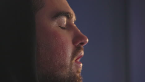 close up of a sweaty sportive man in hoodie having shortness of breath after workout 3