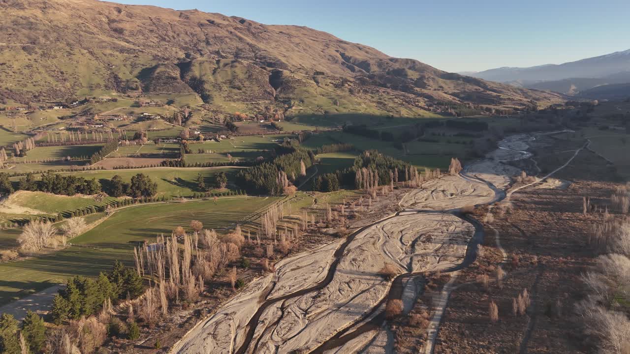 Drone flight over the dry Wanaka riverbed on the South Island of New Zealand during sunset