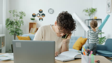 working from home with a playful child