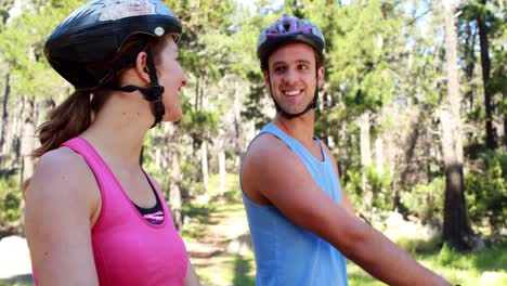 couple biking through a forest