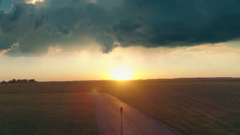 the aerial view on man walking along the runway on the sunny sky background