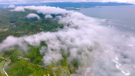 drone flying over clouds revealing scenic chiloe island coastline