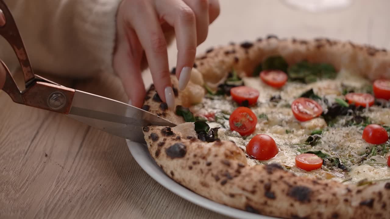 Woman Cutting a Delicious Pizza Slice