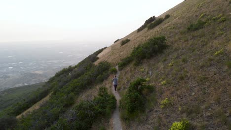 female hiker and puppy dog on outdoor path in utah mountains