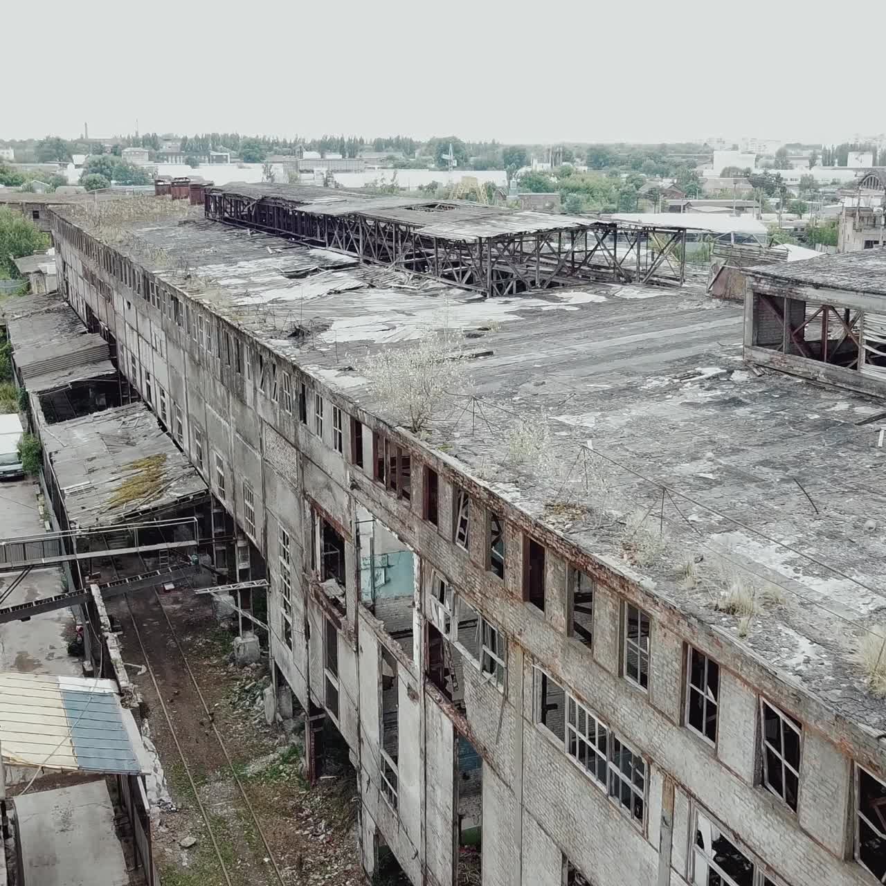 Flight over the destroyed factory. Old industrial building for demolition. Aerial view