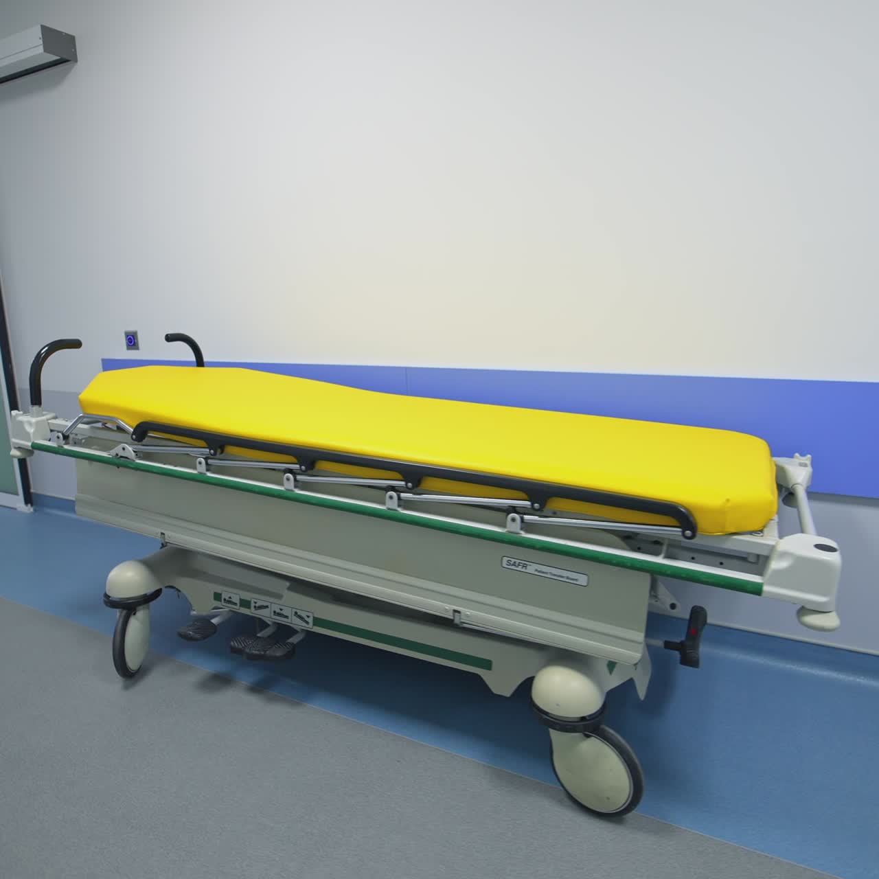 Empty hospital cot in corridor. Corridor operating rooms in modern hospital facilities