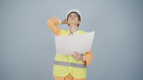 Looking-up,-the-engineer-is-holding-her-hard-hat.