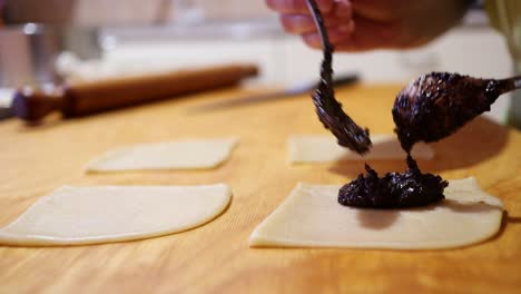 filling the traditional italian pastries with chocolate filling, close up footage