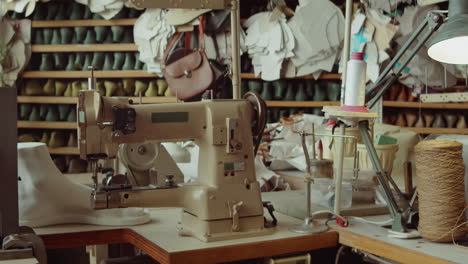 shoemaker workplace with sewing machine in workshop