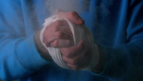 young boxer clapping his wrapped hands together