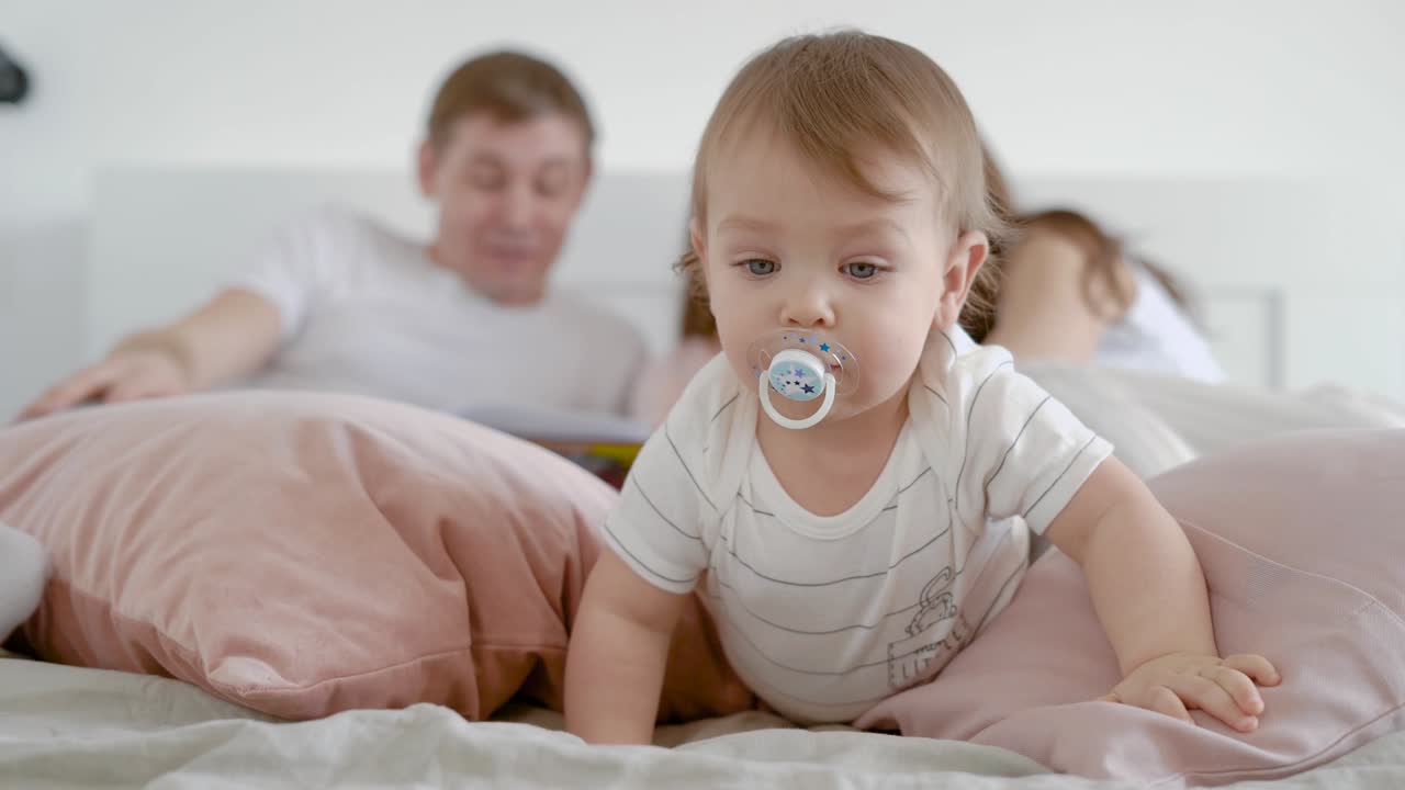 Baby child with pacifier looking concentrated
