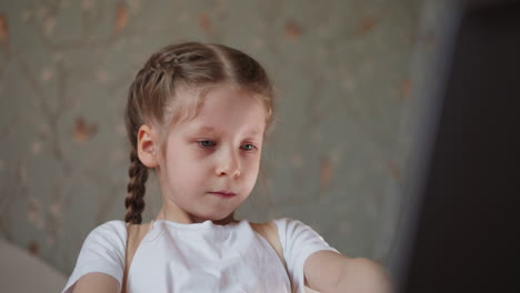 junior schoolgirl finishes playing piece of music on piano