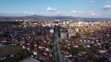 drone shot, city of cacak serbia on sunny summer day, buildings and streets