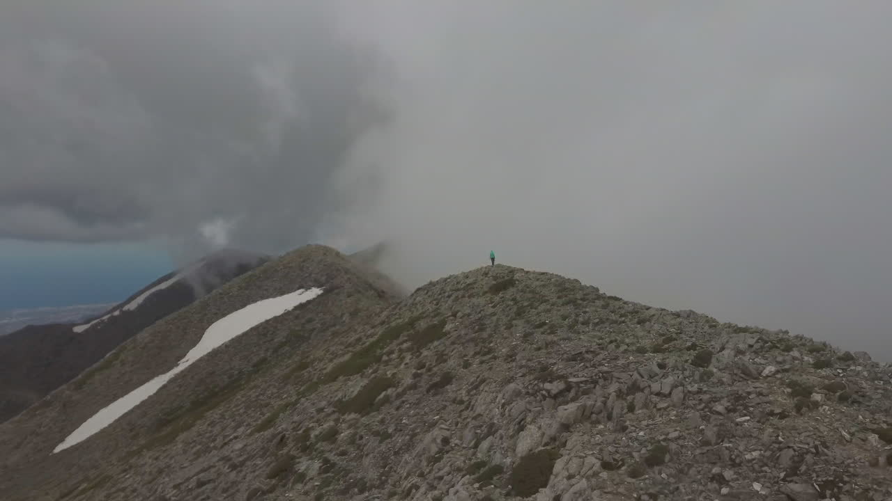 안개 낀 날 산꼭대기를 걷는 하이킹 여성과 남성의 공중 전망