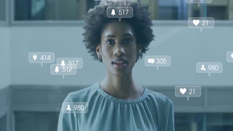 Animation-of-social-media-icons-and-data-processing-over-biracial-businesswoman