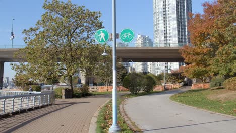 vancouver, canada - an urban panorama featuring a sidewalk, bicycle lane, structure, and elevated roadway - static shot