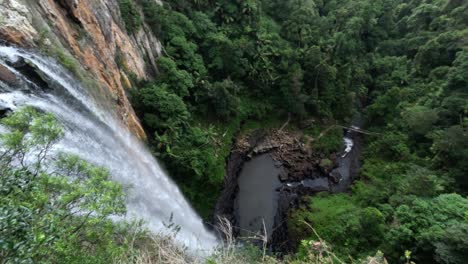 aerial view of a waterfall in a green forest