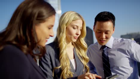 multi ethnic business advisors using tablet on rooftop