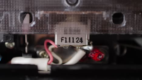 Retro radio tape recorder, audio cassette close-up. Listening to music, old radio boom box player, macro of vintage music listening.