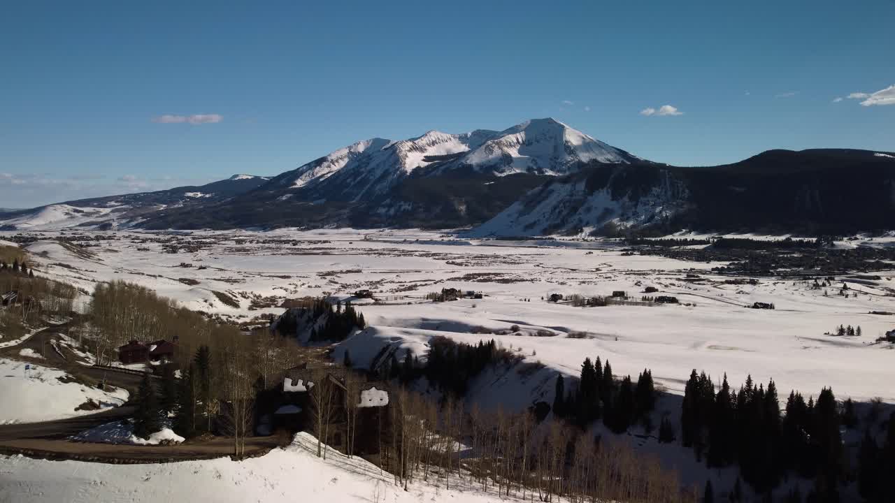 volando hacia las montañas rocosas de colorado cubiertas de nieve durante el invierno, antena