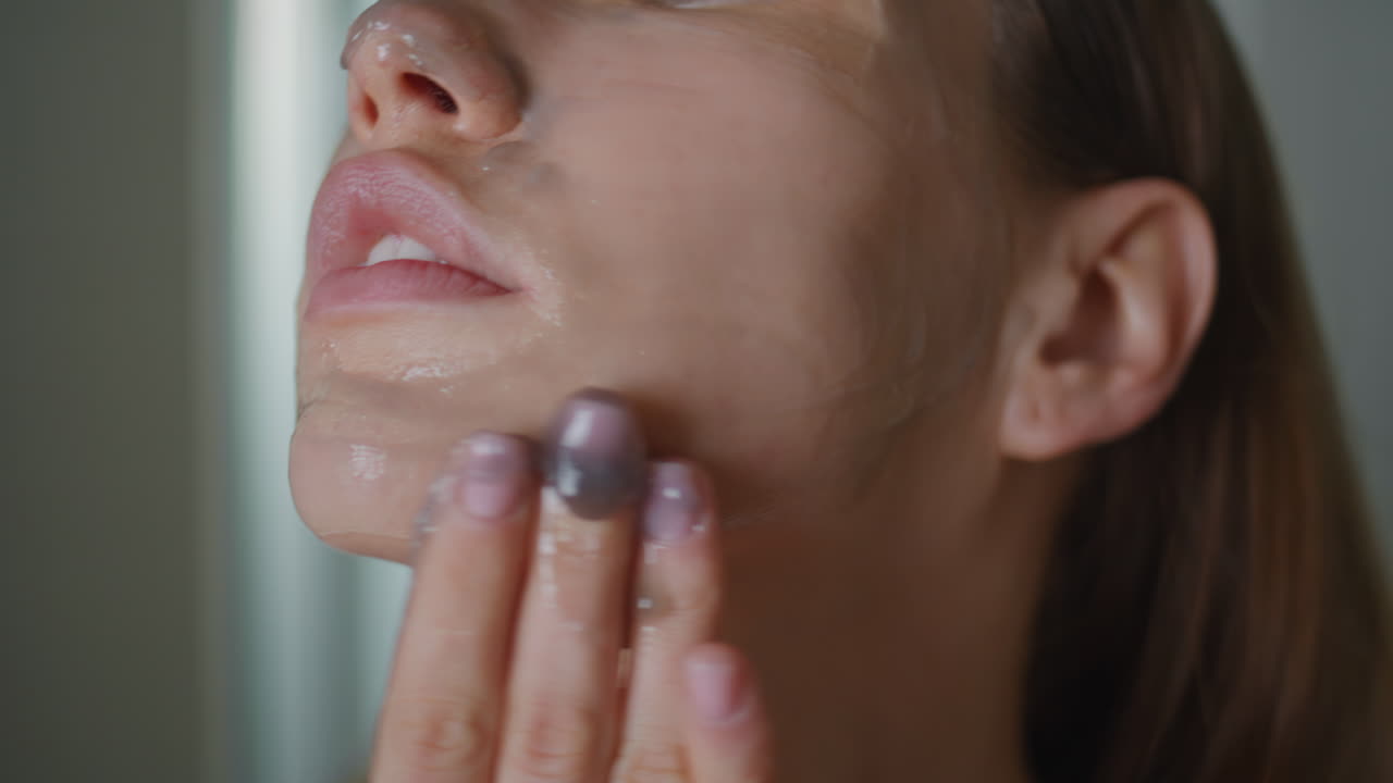 Girl using face mask rubbing on skin closeup. Beauty routine advertisement
