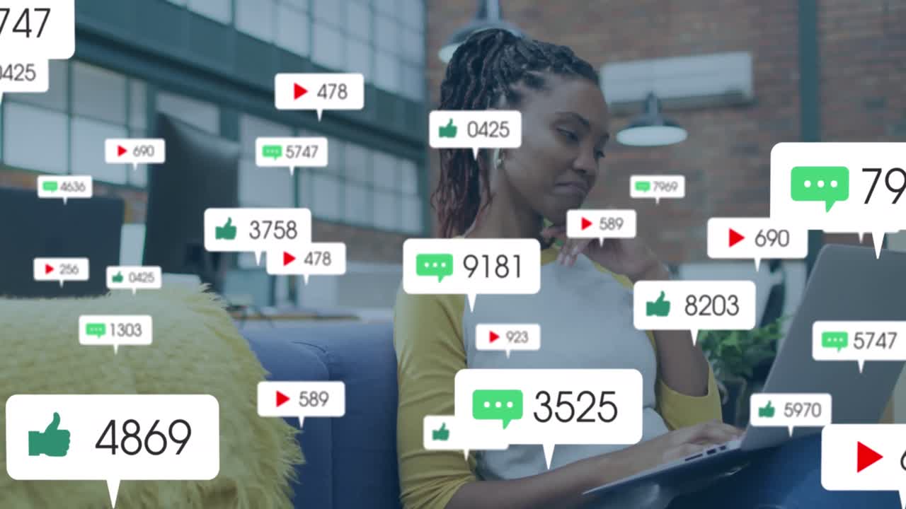 Animation of social media icons with numbers over african american woman using laptop