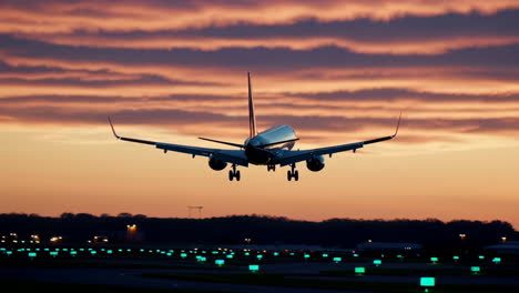 airplane landing at sunset