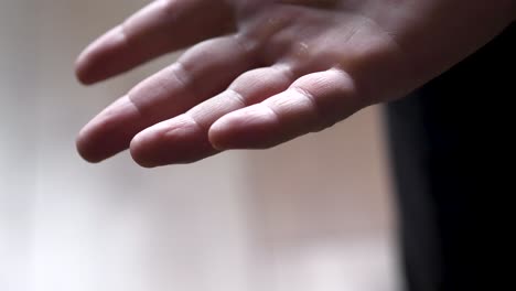 hand-with-wedding-ring-fist-and-drop-ring-down-in-slow-motion-close-up