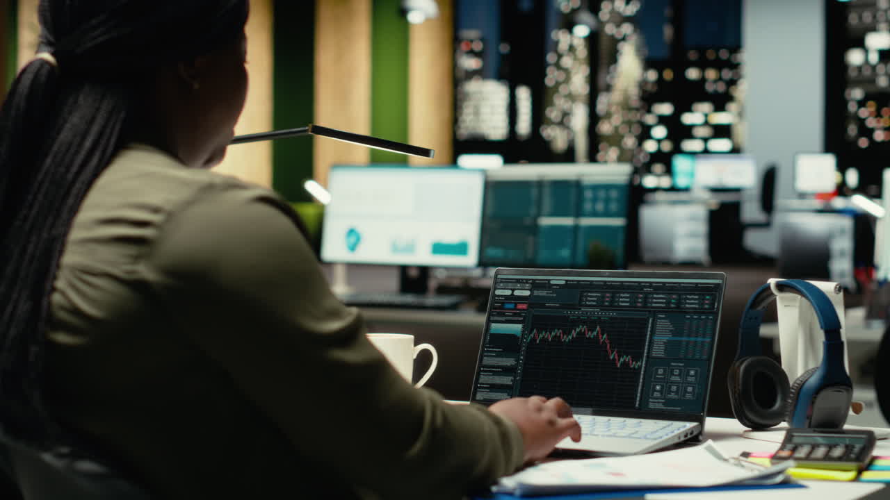 African american staff monitoring live stock trends for cryptocurrency market