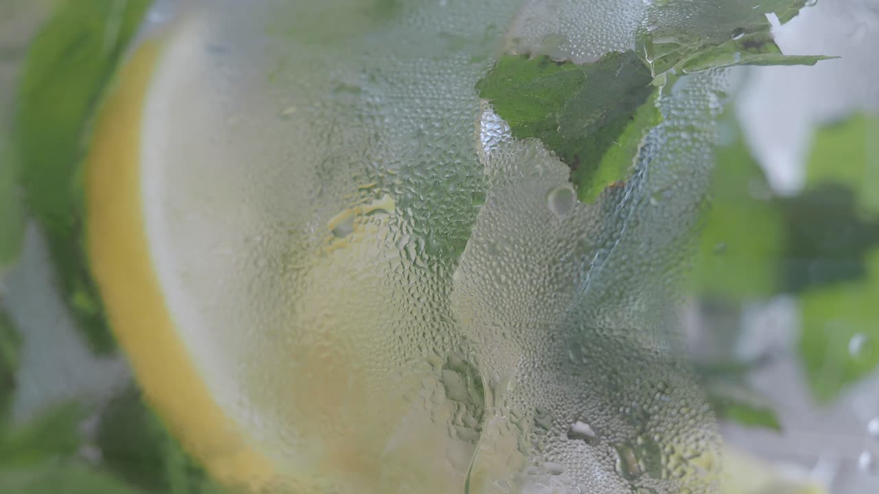 Close-up of a Refreshing Iced Cocktail with Lemon and Mint