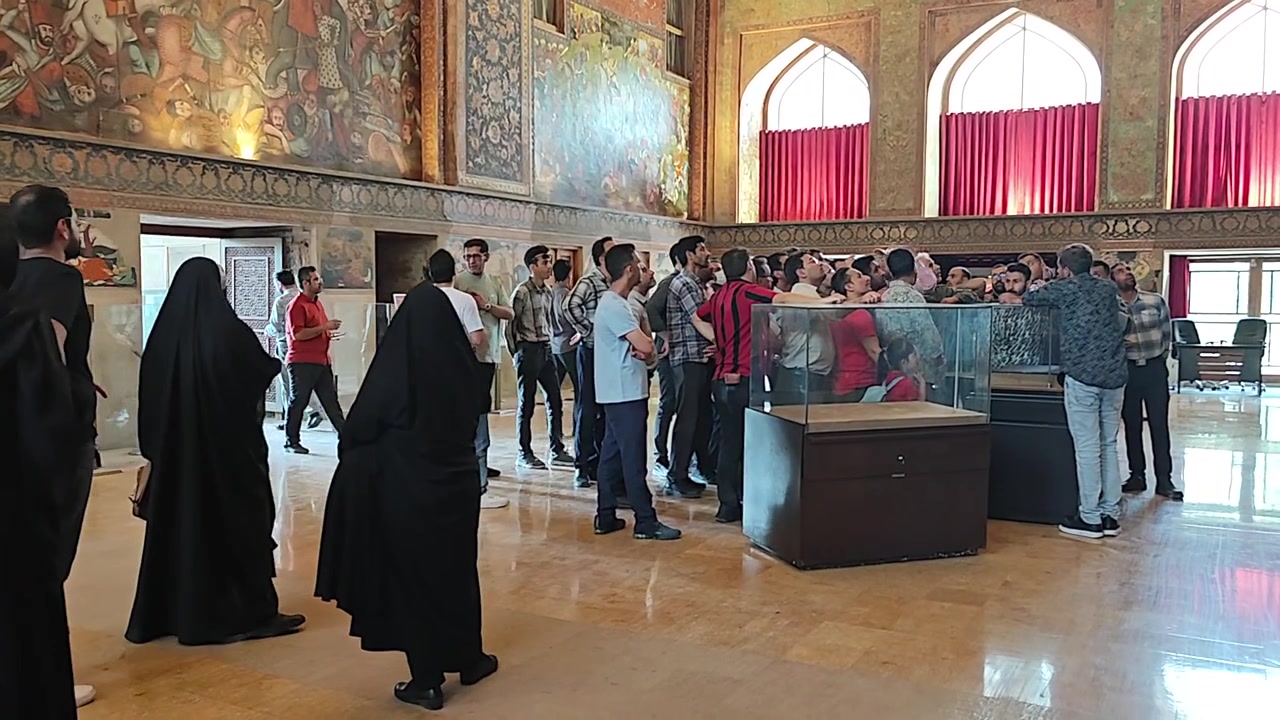Gruppo di turisti che visita una sala di un museo storico.