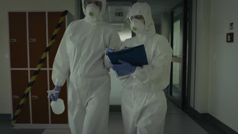 video of employees wearing a protective suits during an inspection