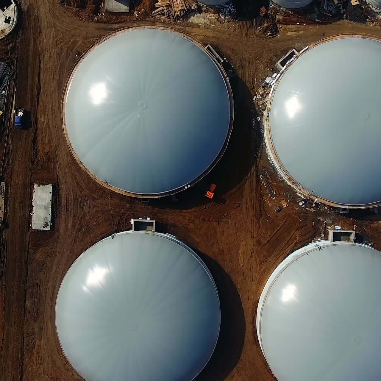 Round gray roofs on construction zone of bio gaz factory. Modern production of ecological fuel