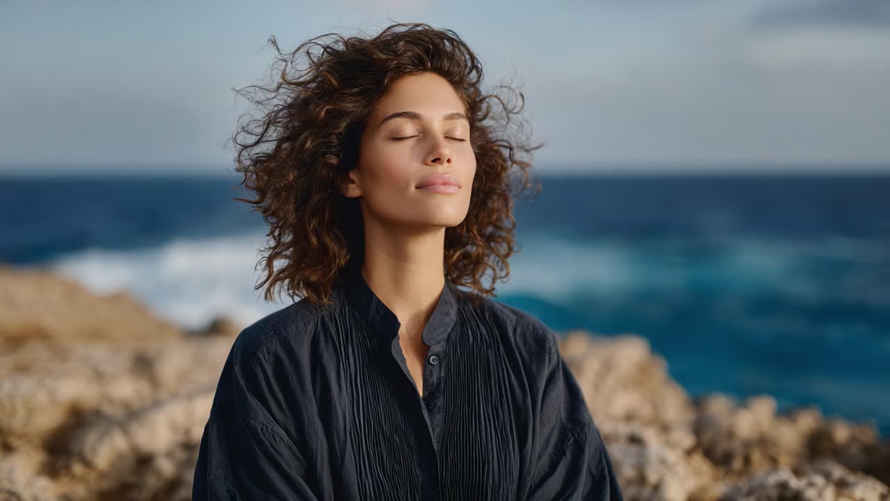 A Serene Moment by the Ocean: A Woman Enjoys the Fresh Breeze, Embracing Nature's Peacefulness with Her Eyes Closed, Surrounded by Beautiful Coastal Scenery