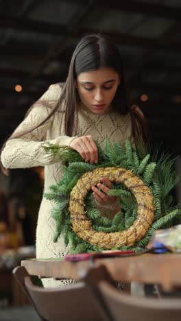 woman making a christmas wreath