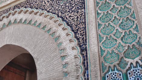 traditional moroccan craftsmanship is displayed on the bab el khemis gate in meknes, morocco, with colorful zellij mosaic tiles and ornate carved stucco arch
