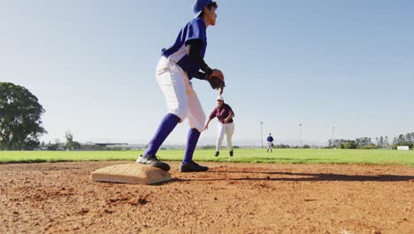 Diverse-female-baseball-players,-fielder-on-base-catching-out-a-running-hitter-on-baseball-field