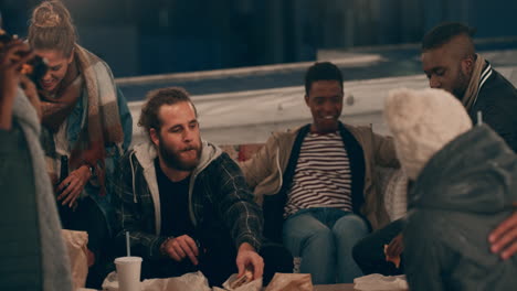 diverse rooftop party friends hanging out chatting having fun socializing together enjoying happy reunion gathering at night