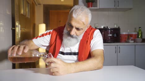 sad man drinking whiskey at home.