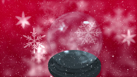 Animation-of-snow-falling-over-snow-globe-on-red-background