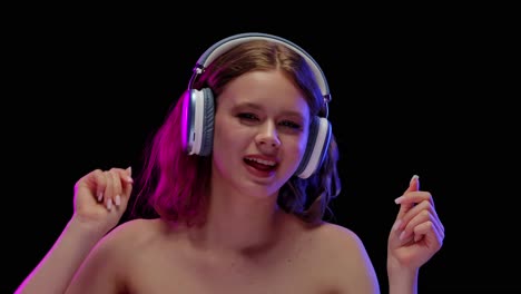 young woman enjoying music with headphones in neon light