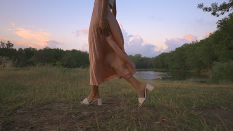 Elegant-Young-Lady-Woman-Walking-Alone-in-Nature-Park-by-River-Lake,-Tracking-Rising-Up-Outside-Shot-of-Slim-Attractive-Girl,-Casual-Trendy-Fashion-Brunette-Stylish-Model