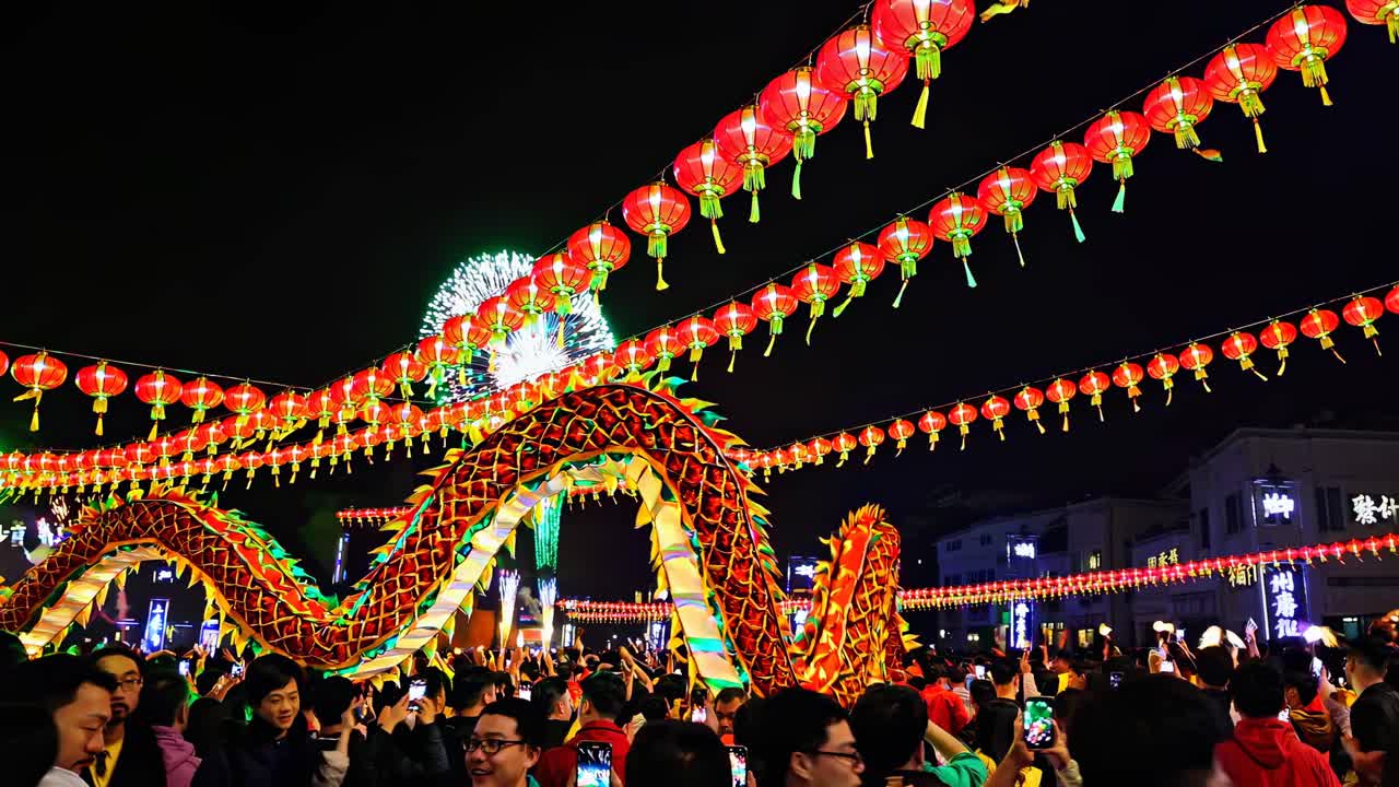 Vibrant festival scene with colorful dragon and lanterns, captured from a low angle