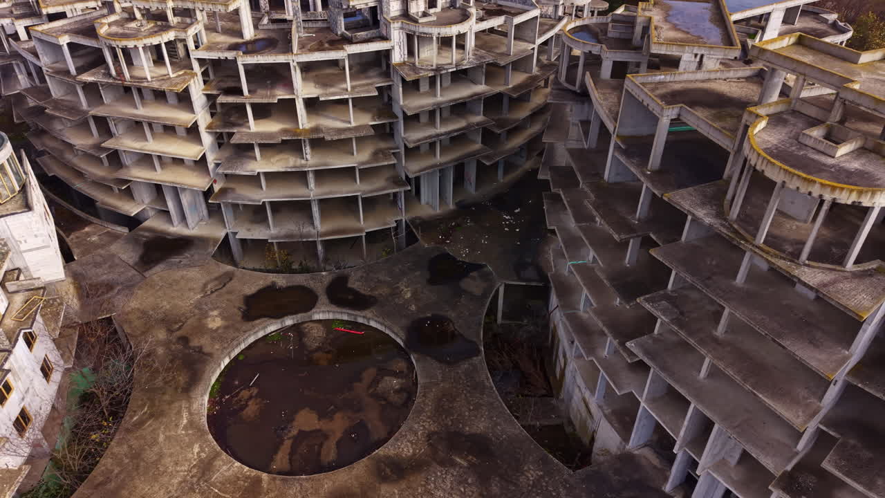 Forgotten structures rise amid nature's reclaiming touch in a desolate urban landscape filled with remnants of a bygone era