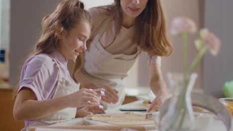 mother and daughter baking cookies