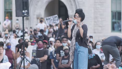 black woman giving a speech at a police brutality protest