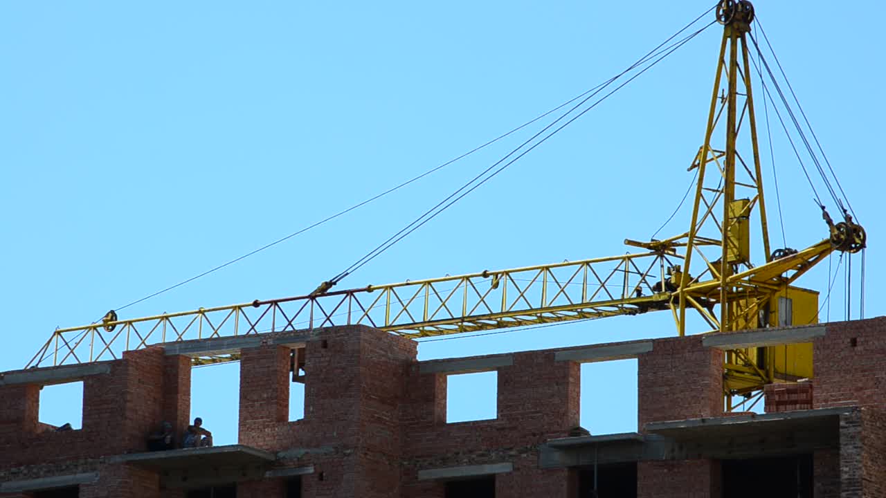 Construction of residential buildings. Construction cranes over houses