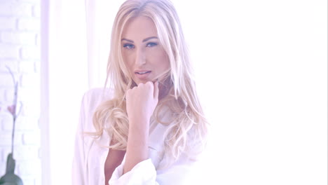 Seductive-Blond-Woman-in-White-Looking-at-Camera